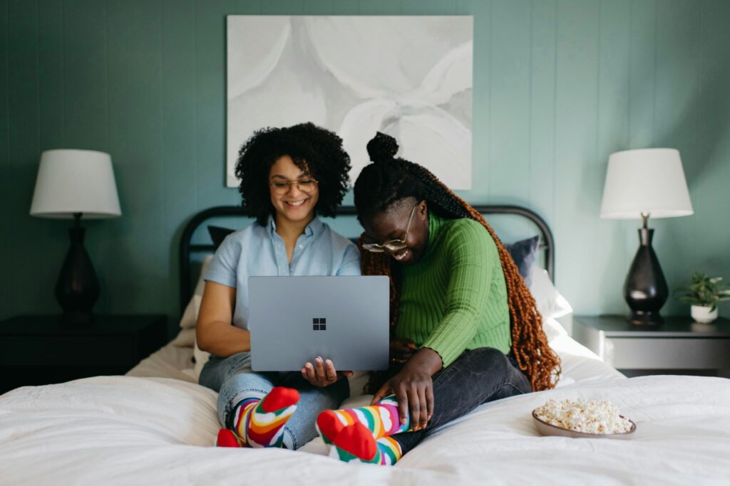 Two women streaming on laptop with in-banner video and programmatic advertising