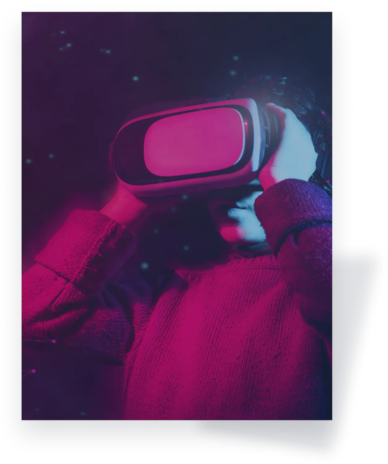 Young person using a virtual reality headset for immersive digital experience in futuristic lighting.